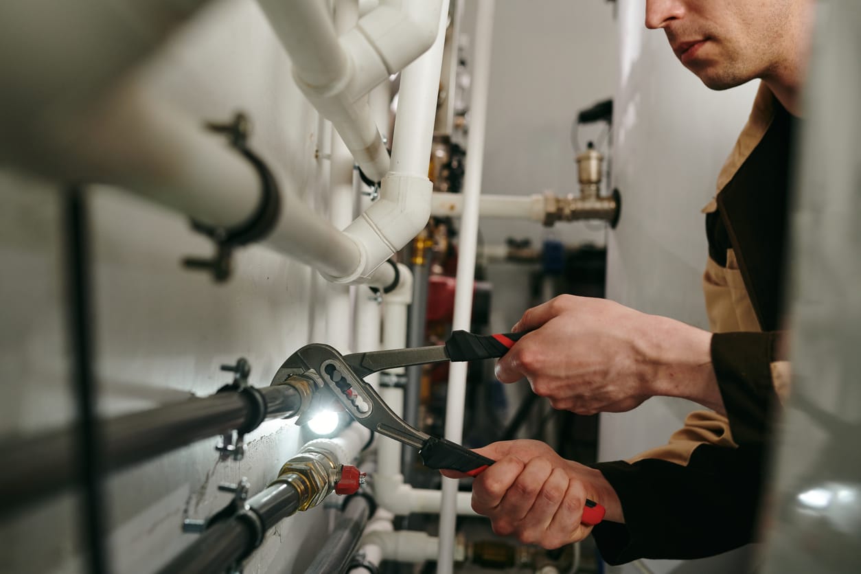Plumbers maintaining commercial plumbing pipes in Denver