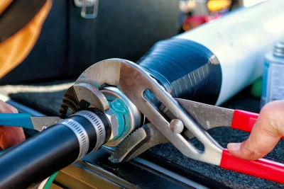 Technician tightening an industrial pipe connection in Denver