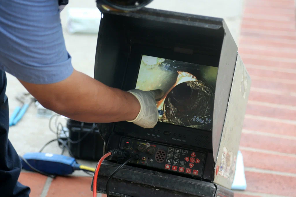 Technician viewing a drain inspection camera in Denver