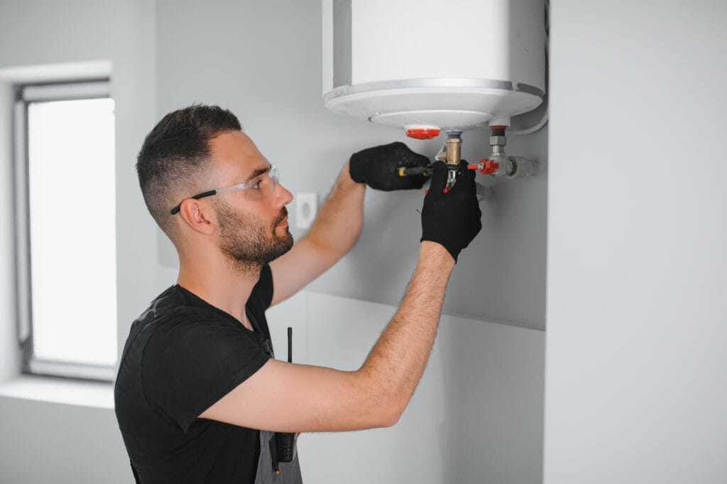Technician performing water heater maintenance in Denver